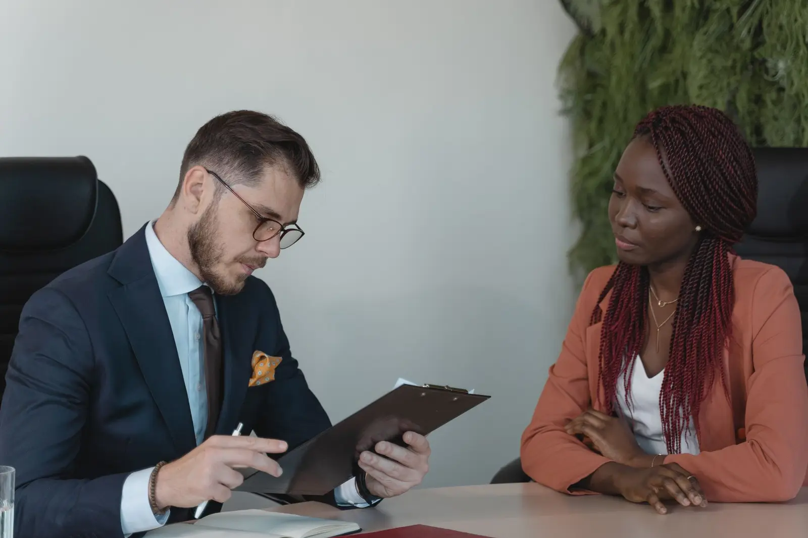 A man and a woman in a job interview at an office desk