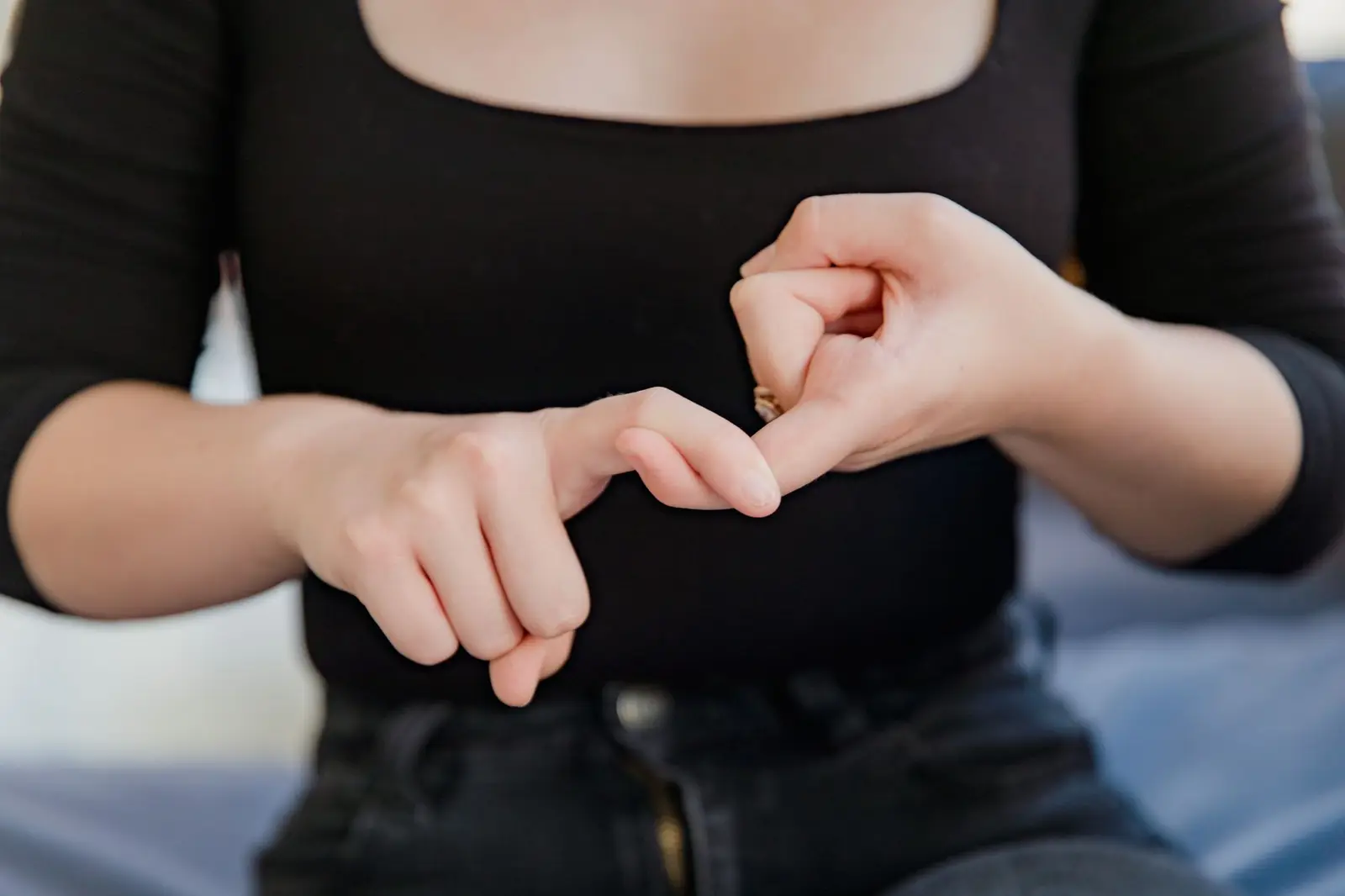 A person's hands making a sign language gesture