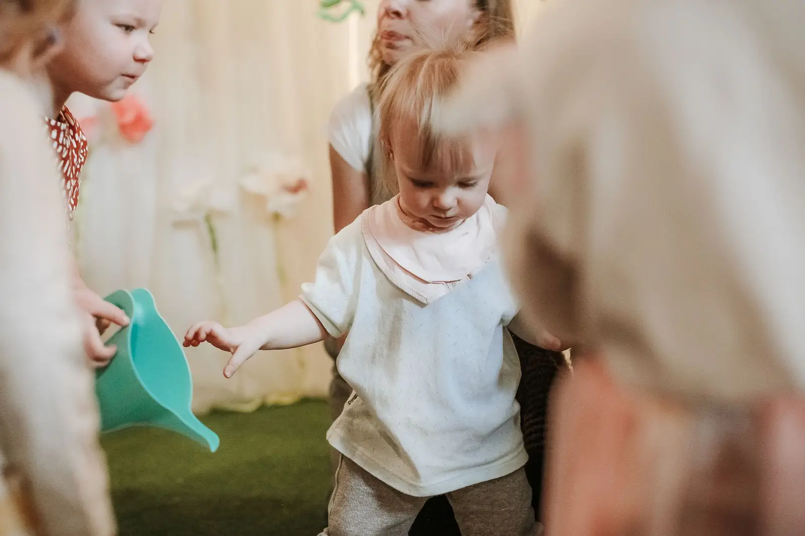 Young children playing and exploring in a bright nursery room