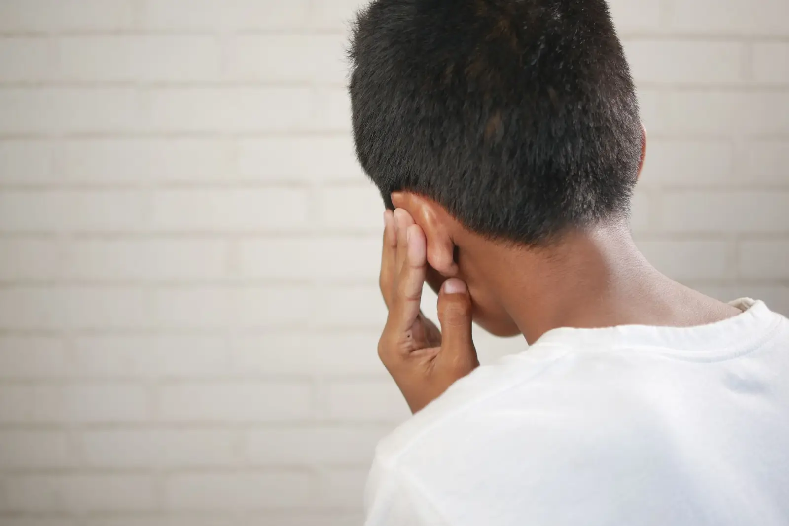 A child covering one ear with a hand