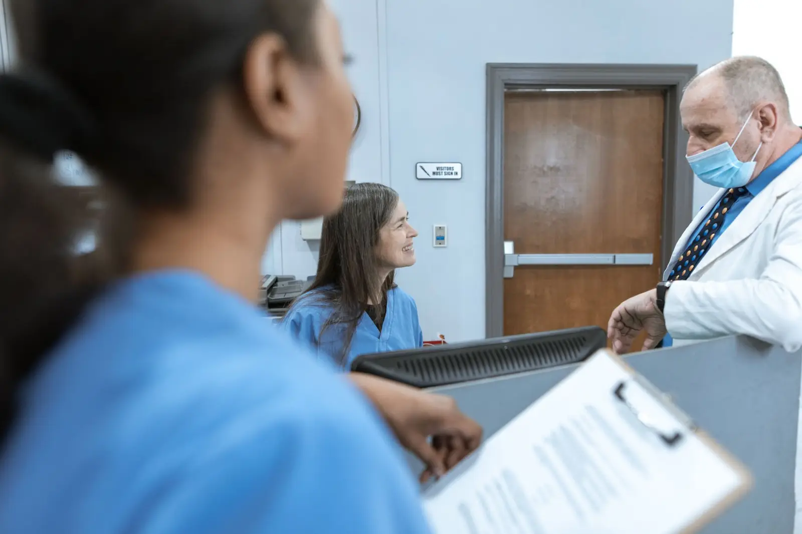 Healthcare professionals talking together at a hospital reception