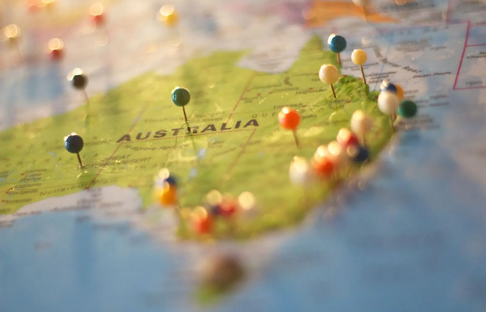 A map of Australia with colourful pins marking cities